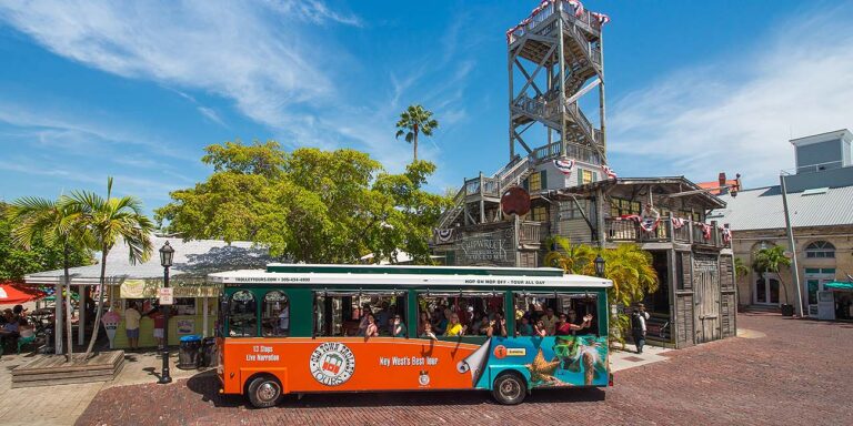 Old Town Trolley Tours driving past Key West Shipwreck Treasure Museum